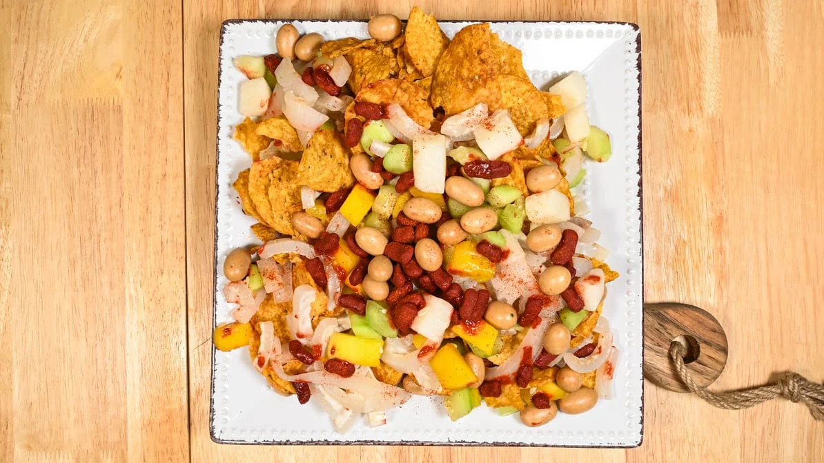 Tostilocos with chips, beans, jicama and mango